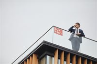 real-estate-agent-standing-on-roof-2021-09-24-04-08-29-utc.jpg