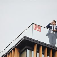 real-estate-agent-standing-on-roof-2021-09-24-04-08-29-utc.jpg