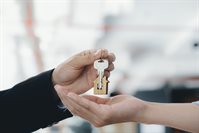 real-estate-agent-holding-key-with-house-shaped-k-2021-09-03-01-33-31-utc.jpg