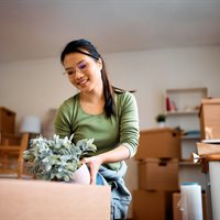 happy-asian-woman-packing-her-plants-while-relocat-2023-11-27-04-52-15-utc.jpg