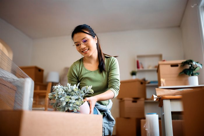 happy-asian-woman-packing-her-plants-while-relocat-2023-11-27-04-52-15-utc.jpg